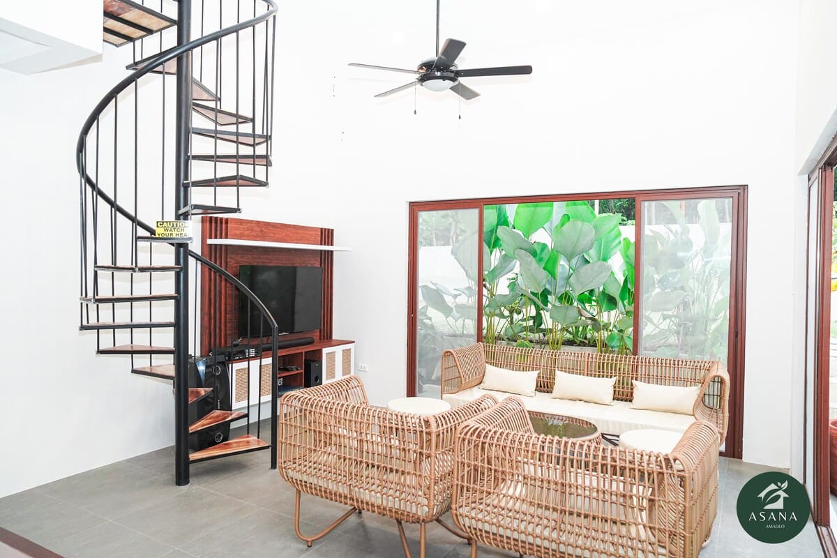 Rattan sofa beside the sliding glass doors to the garden
