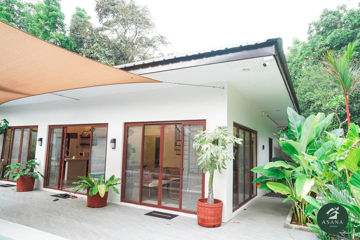 Villa exterior with the orange shade sail over the pool deck