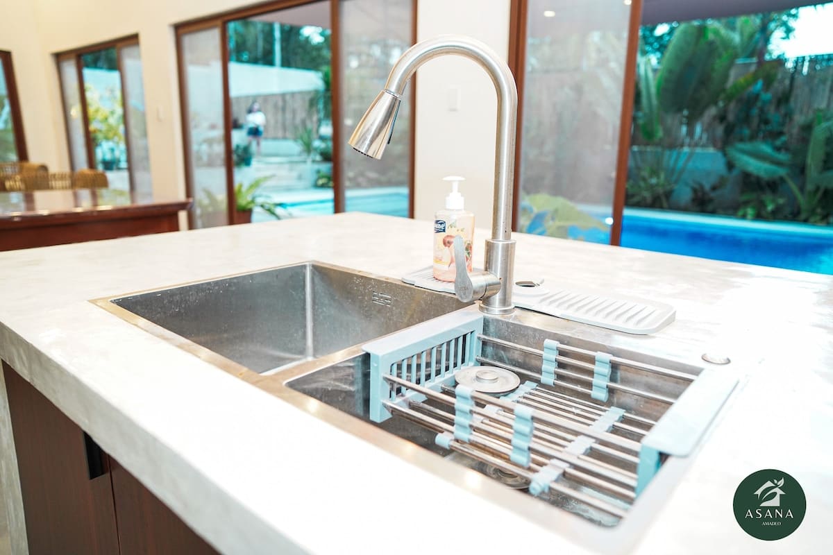 Kitchen sink with the pool visible through the window