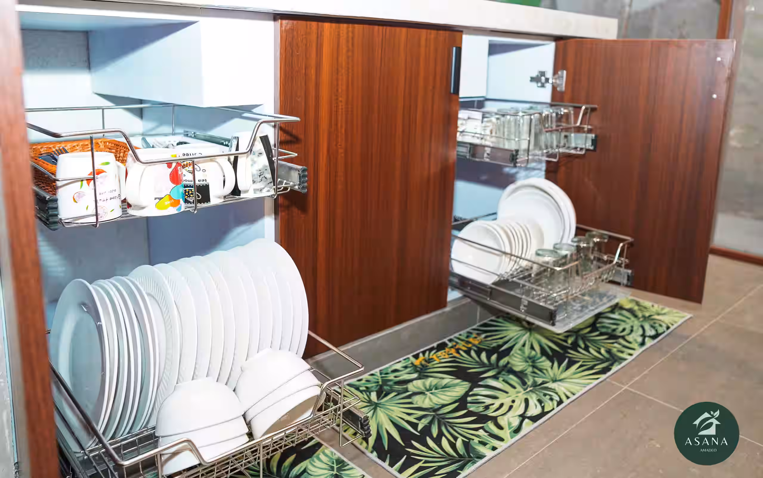 Pull-out dish racks in the kitchen island holding plates, bowls, and mugs