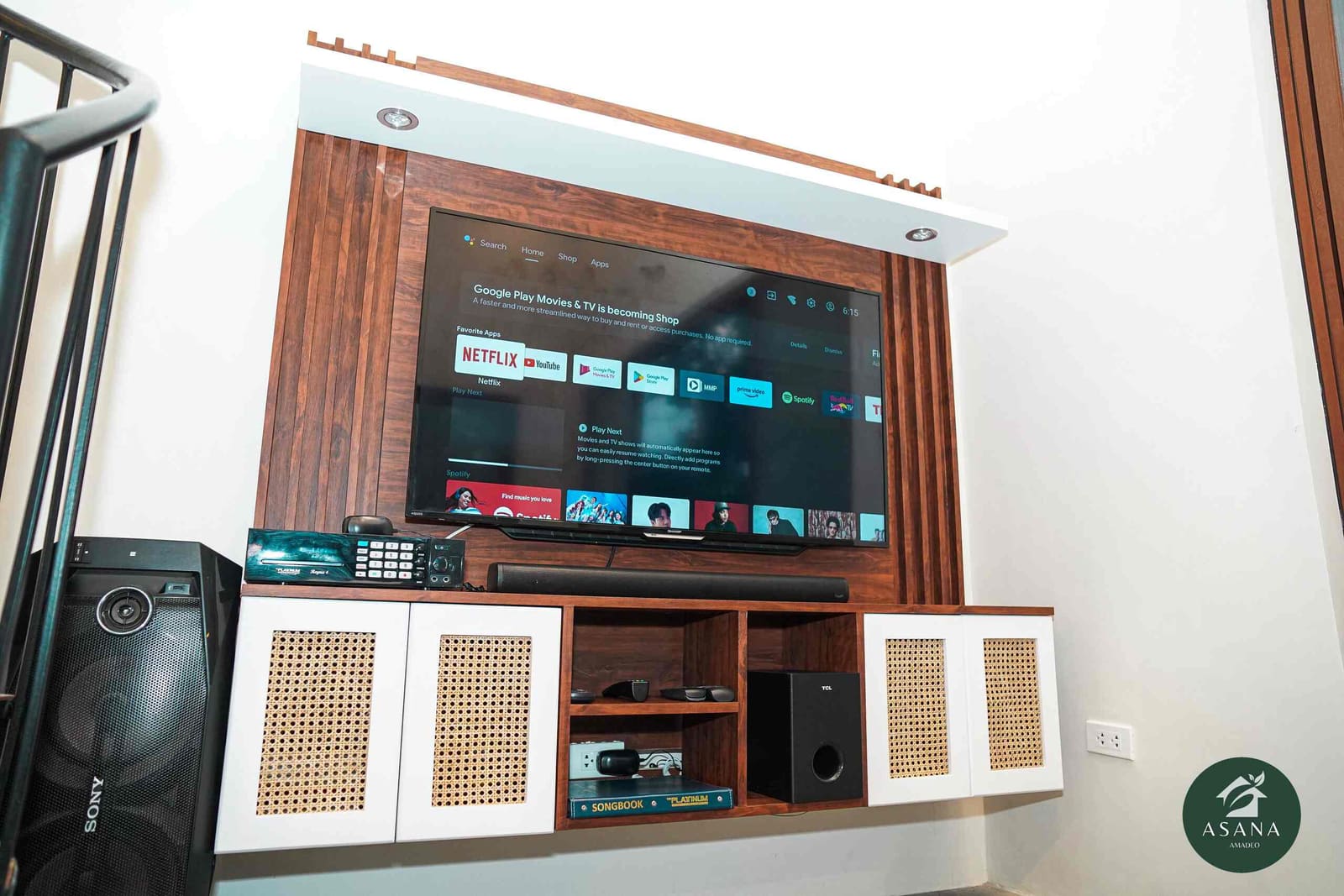 Entertainment center with a smart TV, soundbar, and karaoke mixer