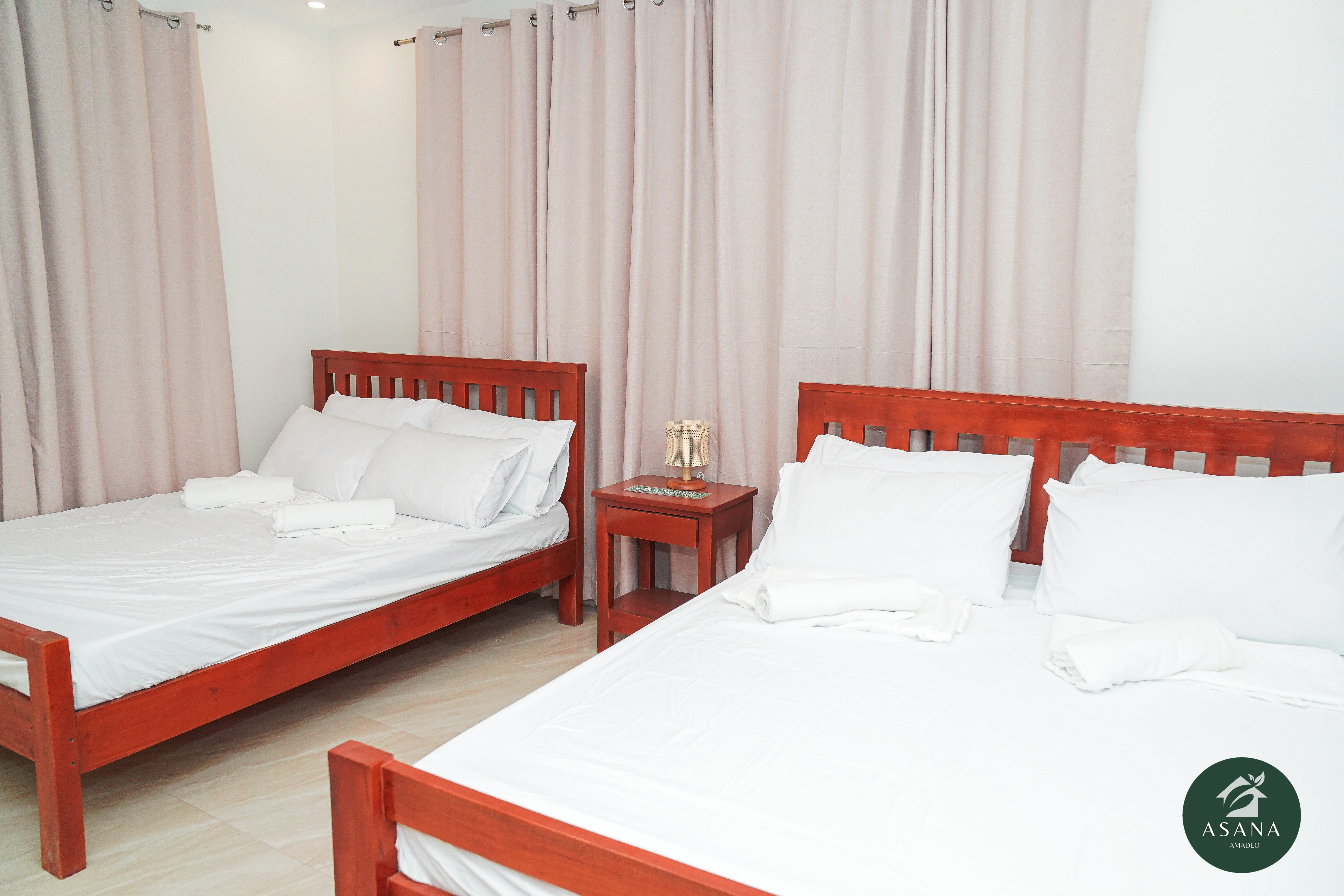 Bedroom 1 with two queen beds and air conditioning
